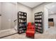Upstairs sitting area has two bookshelves, a red chair and ottoman and a staircase at 10066 Belvedere Cir, Lone Tree, CO 80124