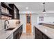 Finished basement wet bar with granite counters, wood floors, and a door to the wine cellar at 445 Brendon Ct, Castle Pines, CO 80108