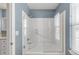 Bathroom with white tile shower and glass enclosure at 445 Brendon Ct, Castle Pines, CO 80108
