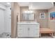 Bathroom with a white vanity, drawers, and a bench, with decoratively tiled flooring at 445 Brendon Ct, Castle Pines, CO 80108