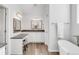 Bathroom features a makeup vanity and sink with a mirror as well as a soaking tub at 445 Brendon Ct, Castle Pines, CO 80108