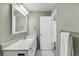 Bathroom featuring a single vanity with granite countertop and a large mirror at 445 Brendon Ct, Castle Pines, CO 80108