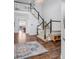 Stunning foyer showcasing a staircase, hardwood floors, and an open layout into other living spaces at 445 Brendon Ct, Castle Pines, CO 80108