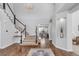 Grand foyer with hardwood floors, a staircase, and a view into a bright and airy office at 445 Brendon Ct, Castle Pines, CO 80108