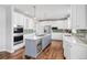Spacious kitchen boasts a large island with a wine fridge, white cabinets, and stainless steel appliances at 445 Brendon Ct, Castle Pines, CO 80108