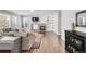 Cozy living room with a stone fireplace, built-in bookshelves, and hardwood floors at 445 Brendon Ct, Castle Pines, CO 80108