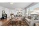 Spacious living room with hardwood floors and an open layout to the kitchen and dining area at 445 Brendon Ct, Castle Pines, CO 80108