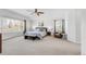 Bright primary bedroom with a ceiling fan, large windows and neutral carpet at 445 Brendon Ct, Castle Pines, CO 80108