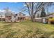 Large backyard offers a spacious deck, lush lawn, and mature trees at 537 S Grape St, Denver, CO 80246