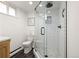 Modern bathroom features glass enclosed shower with sleek black hardware and stone flooring at 537 S Grape St, Denver, CO 80246