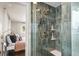 Modern shower with sleek tile, dual shower heads, and a convenient built-in shelving unit at 537 S Grape St, Denver, CO 80246