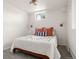 White bedroom with modern lighting, comfortable queen bed, and neutral carpeting at 537 S Grape St, Denver, CO 80246