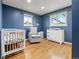 Cozy Bedroom with a crib, chair, and changing table, illuminated by natural light at 537 S Grape St, Denver, CO 80246