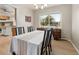 Bright dining room features wood floors, chandelier, and a large window providing ample natural light at 537 S Grape St, Denver, CO 80246