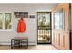 Open entryway with stylish coat rack and bench beside a window and decorative security door at 537 S Grape St, Denver, CO 80246