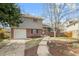 Charming two-story home with brick accents, a manicured lawn, and blossoming trees at 537 S Grape St, Denver, CO 80246
