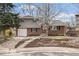 Charming two-story home with brick and siding, a well-manicured lawn, and a blossoming tree in the front yard at 537 S Grape St, Denver, CO 80246