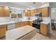 The kitchen features wood cabinets, white counters, stainless appliances, and a large sink under the window at 537 S Grape St, Denver, CO 80246