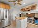 Kitchen with an island with butcher block countertop and lots of cabinets and stainless steel fridge at 537 S Grape St, Denver, CO 80246