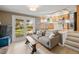 Comfortable living room with fireplace, mantel, and sliding doors to the backyard and adjacent kitchen area at 537 S Grape St, Denver, CO 80246