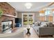 Comfortable living room with fireplace, mantel, and sliding doors to the backyard at 537 S Grape St, Denver, CO 80246
