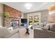 Cozy living room features a brick fireplace, comfortable seating, and a sliding glass door to the backyard at 537 S Grape St, Denver, CO 80246