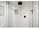 Shower with black hardware, white subway tile and a pebble feature at 537 S Grape St, Denver, CO 80246