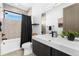 Modern bathroom with a sleek vanity, tile shower, and black accents at 4752 Eliot St, Denver, CO 80211