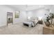 This bright bedroom is furnished with a Queen bed, bench, and side tables at 4752 Eliot St, Denver, CO 80211