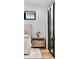 Bright bedroom with bedside table, flowers, and glass door access to the outside at 4752 Eliot St, Denver, CO 80211
