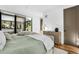 Well-lit bedroom boasts a plush bed, dresser, and access to an outdoor patio at 4752 Eliot St, Denver, CO 80211