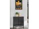 Hallway cabinet with decorative items and an art print at 4752 Eliot St, Denver, CO 80211