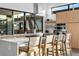 Kitchen island with barstool seating, modern cabinetry, and large windows for natural light at 4752 Eliot St, Denver, CO 80211