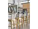 Modern kitchen with wood cabinets, stainless steel appliances, and breakfast bar seating at 4752 Eliot St, Denver, CO 80211