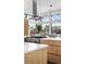 Bright kitchen featuring a cooktop island, modern vent hood, and a stylish chandelier at 4752 Eliot St, Denver, CO 80211