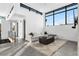 Bright living room features high ceilings, large windows, and modern furnishings at 4752 Eliot St, Denver, CO 80211