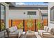 Cozy outdoor patio with modern seating, wooden fence, and lush greenery, creating a relaxing retreat at 4752 Eliot St, Denver, CO 80211