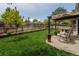 Lush backyard with a pergola, green lawn, and well-maintained wood fence at 17018 Carr Ave, Parker, CO 80134