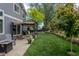 Spacious backyard featuring a pergola, grassy lawn, mature trees and a privacy fence at 17018 Carr Ave, Parker, CO 80134