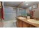 Bathroom with a double sink vanity, shower with sliding glass doors, and decorative touches at 17018 Carr Ave, Parker, CO 80134