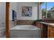 Modern bathroom featuring a tub, shower with decorative tile, and a window allowing natural light at 17018 Carr Ave, Parker, CO 80134