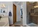 Bright bathroom featuring a tiled walk-in shower and vanity with sink at 17018 Carr Ave, Parker, CO 80134
