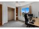 A well-lit bedroom featuring a spacious closet, large window and modern desk setup at 17018 Carr Ave, Parker, CO 80134