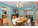 Bright dining room showcasing an elegant chandelier and seamlessly connecting to a living area at 17018 Carr Ave, Parker, CO 80134