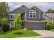 Exterior front view of a two-story home with a gray color scheme, and a well-manicured lawn at 17018 Carr Ave, Parker, CO 80134