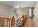 Hallway with wood floors and railing overlooking a naturally lit living room with stairs at 17018 Carr Ave, Parker, CO 80134