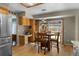 Bright eat-in kitchen featuring wood floors, backyard access, and updated stainless refrigerator at 17018 Carr Ave, Parker, CO 80134