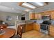 Contemporary kitchen with granite counters, oak cabinets, stainless appliances, and access to living room at 17018 Carr Ave, Parker, CO 80134