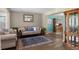 Inviting living room featuring stylish furnishings, a decorative mirror and beautiful wood floors at 17018 Carr Ave, Parker, CO 80134