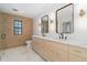 Bright bathroom with double vanity, marble countertops and a walk-in shower at 715 Glencoe St, Denver, CO 80220